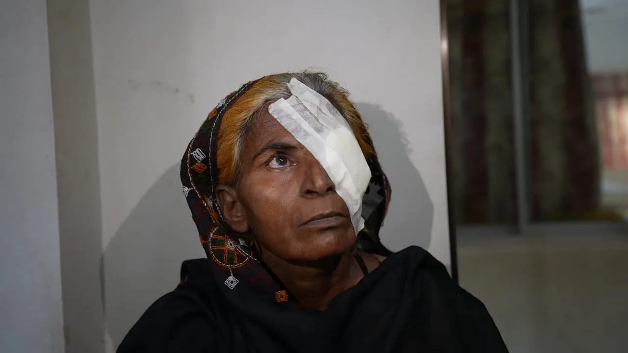 Beneficiary wearing an eye dressing after treatment