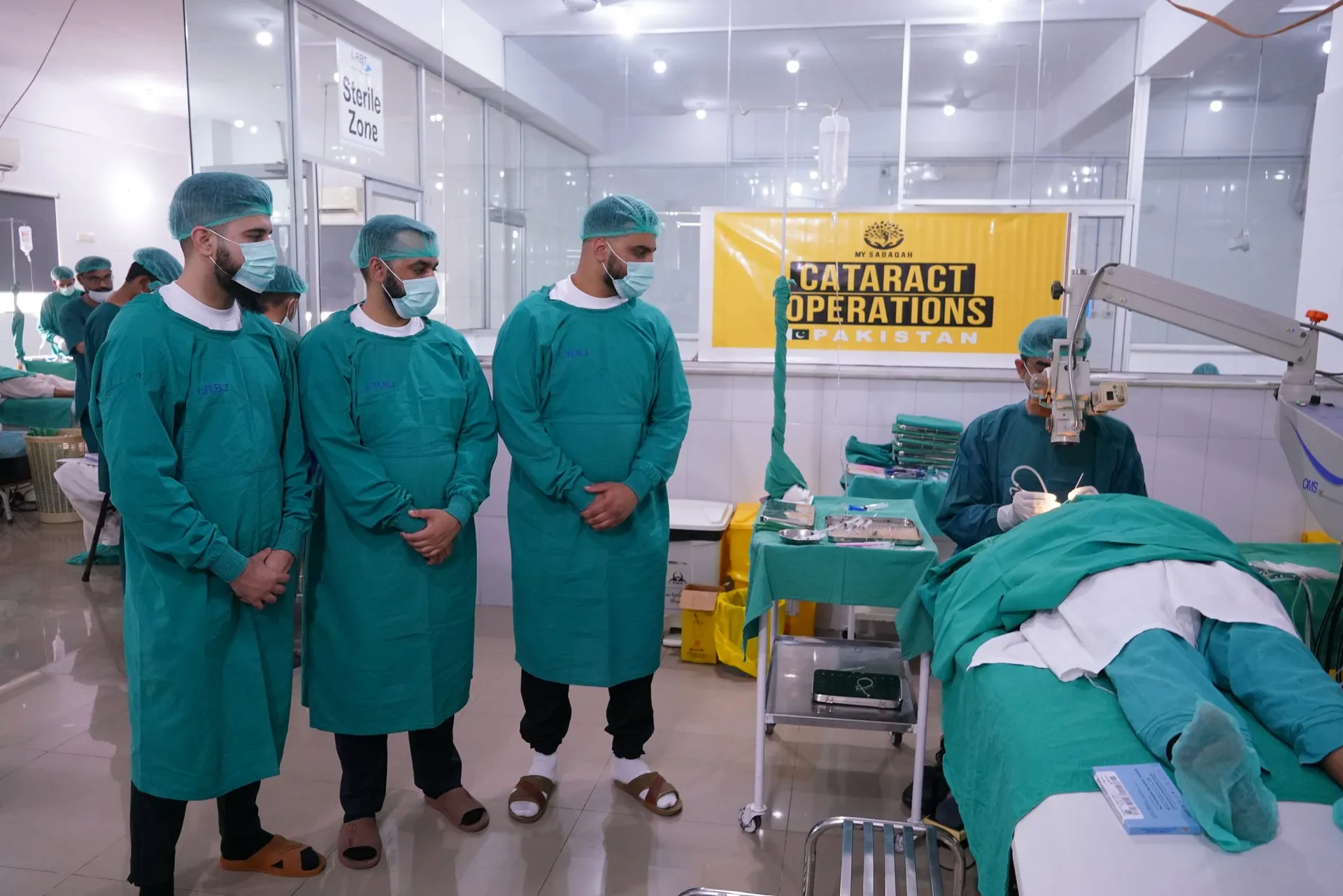 Visiting team alongside the local surgical team in theatre