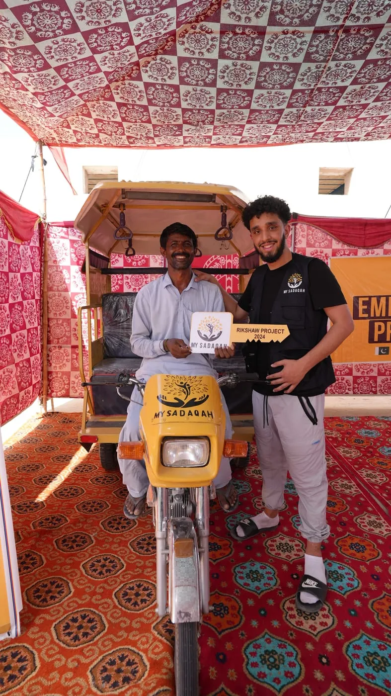 A rickshaw being handed over to a family through the Empowerment Programme